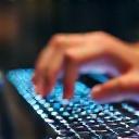 Hands typing on a laptop, representing the implementation and execution phase.